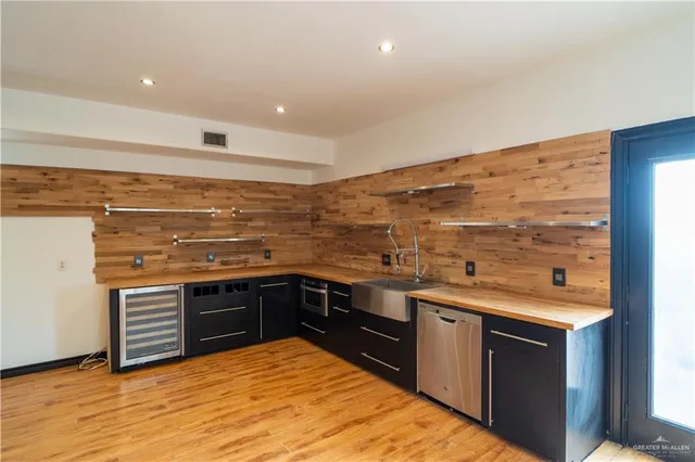 a kitchen with stainless steel appliances granite countertop a sink and cabinets