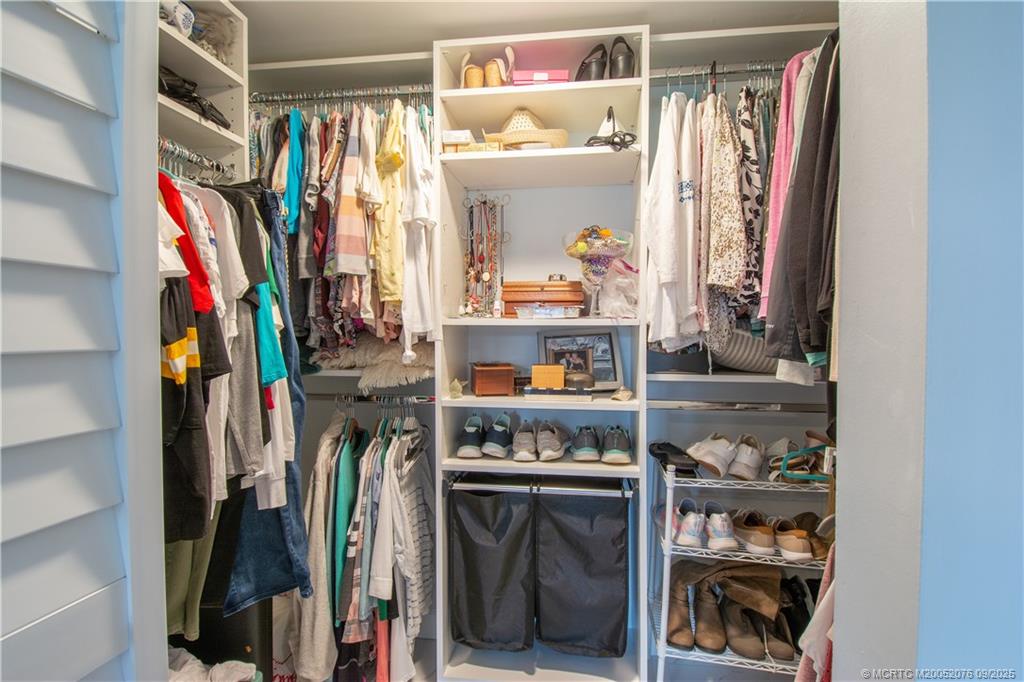 1866 Southwest Palm City Road, Unit 101 Stuart, FL 34994 - Photo 12 of 23 a view of walk in closet with clothes and shoes