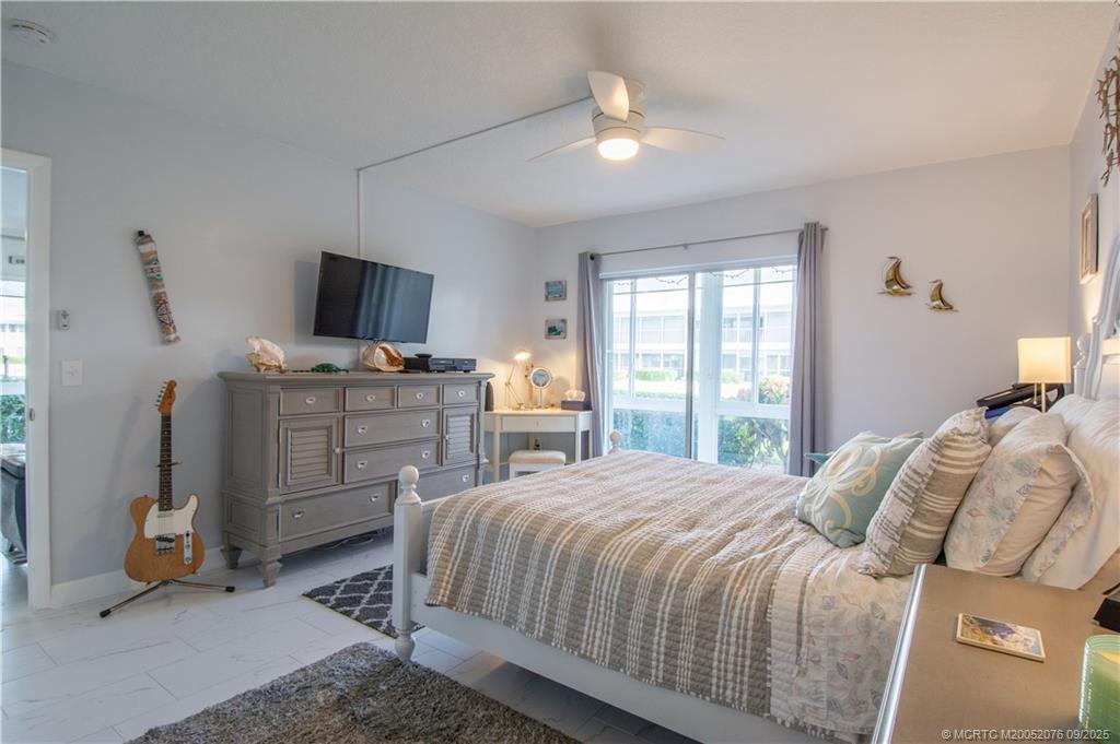 1866 Southwest Palm City Road, Unit 101 Stuart, FL 34994 - Photo 16 of 23 a bedroom with a bed and furniture