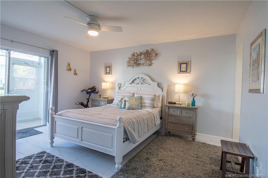 1866 Southwest Palm City Road, Unit 101 Stuart, FL 34994 - Photo 21 of 23 a bedroom with a bed and a table in it