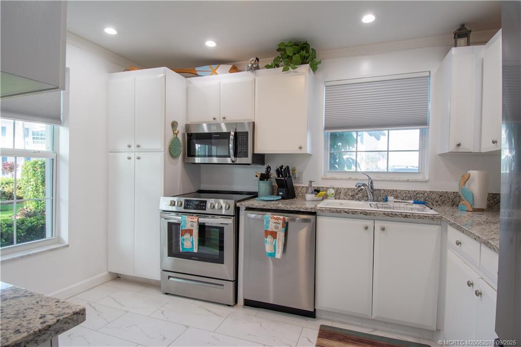 1866 Southwest Palm City Road, Unit 101 Stuart, FL 34994 - Photo 4 of 23 a kitchen with a sink stove and cabinets