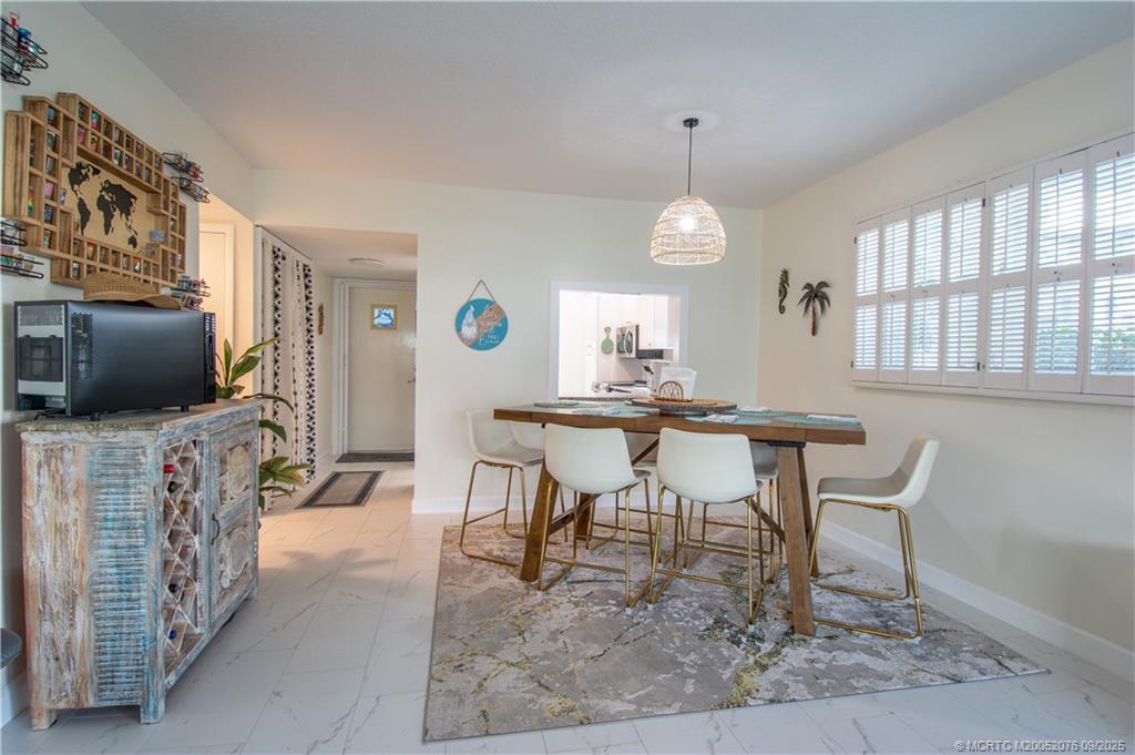 1866 Southwest Palm City Road, Unit 101 Stuart, FL 34994 - Photo 6 of 23 a living room with furniture and a flat screen tv