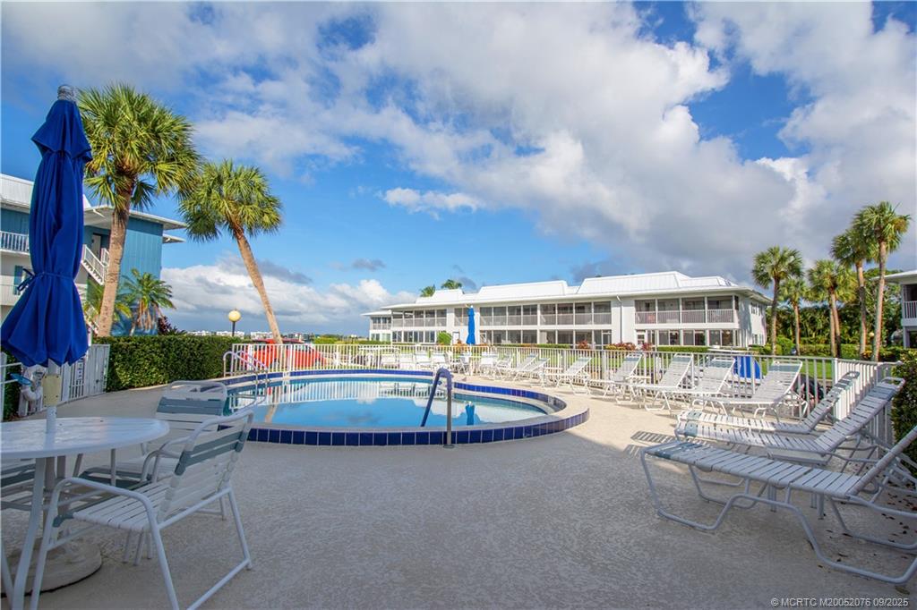 1866 Southwest Palm City Road, Unit 101 Stuart, FL 34994 - Photo 8 of 23 an outdoor space with swimming pool and furniture