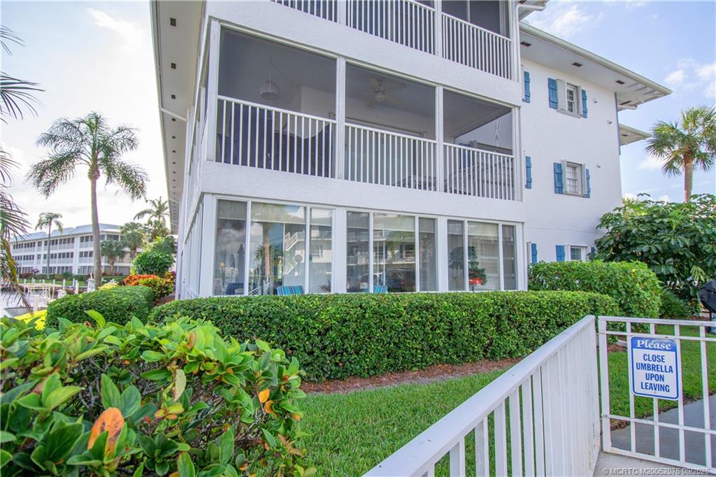 1866 Southwest Palm City Road, Unit 101 Stuart, FL 34994 - Photo 9 of 23 a view of a house with a yard and potted plants