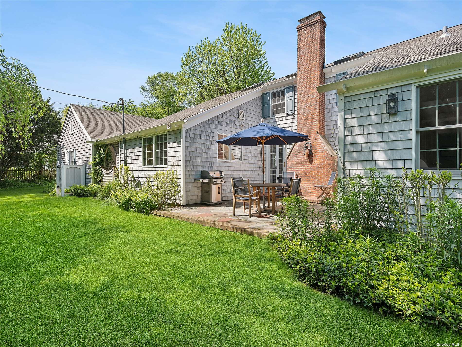 41 East Hampton, undefined 00000 - Photo 14 of 14 a front view of a house with patio and garden