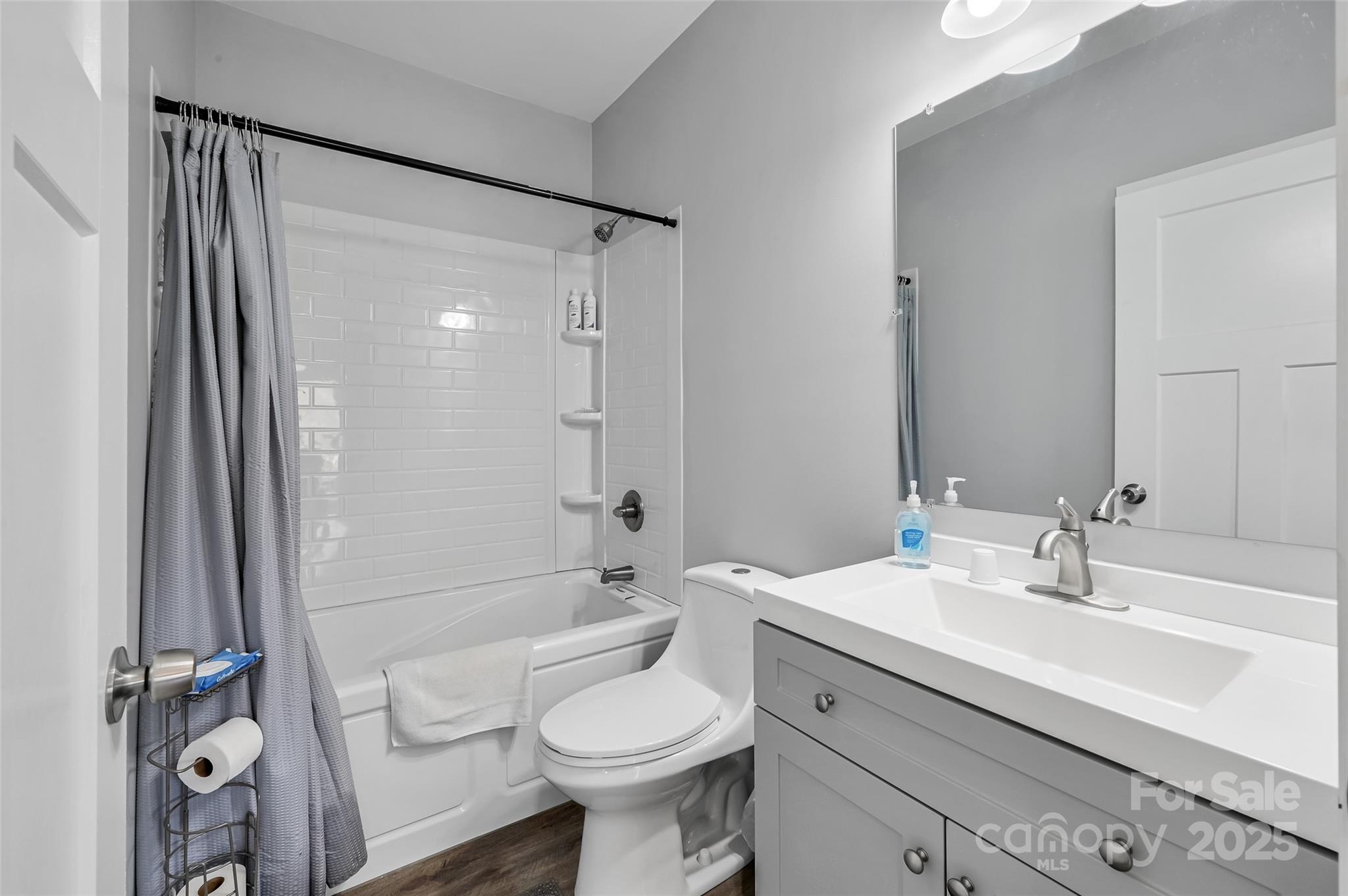 811 Golf Course Road Old Fort, NC 28762 - Photo 21 of 37 a bathroom with a sink toilet a mirror and shower