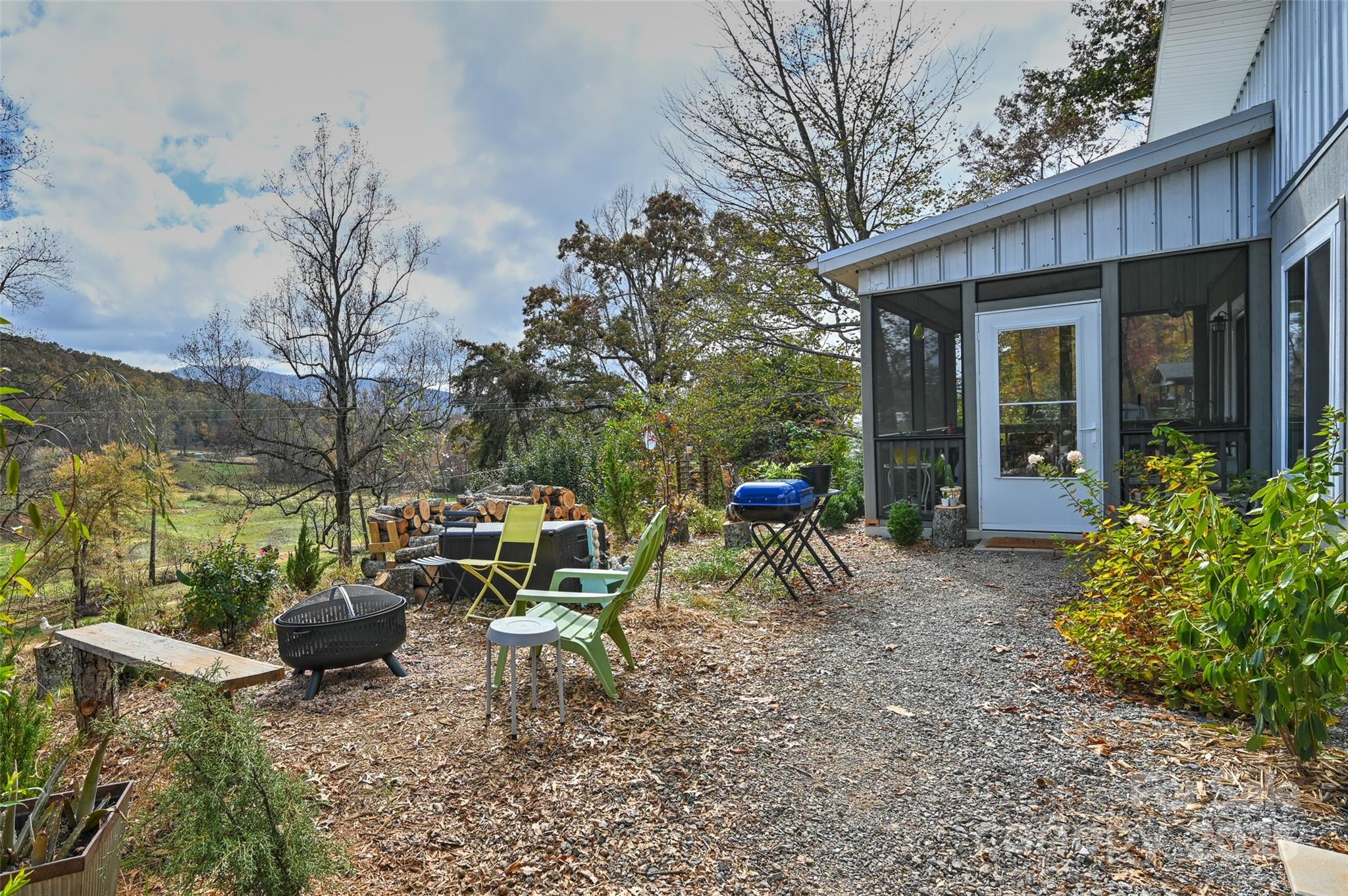811 Golf Course Road Old Fort, NC 28762 - Photo 31 of 37 a backyard of a house with table and chairs