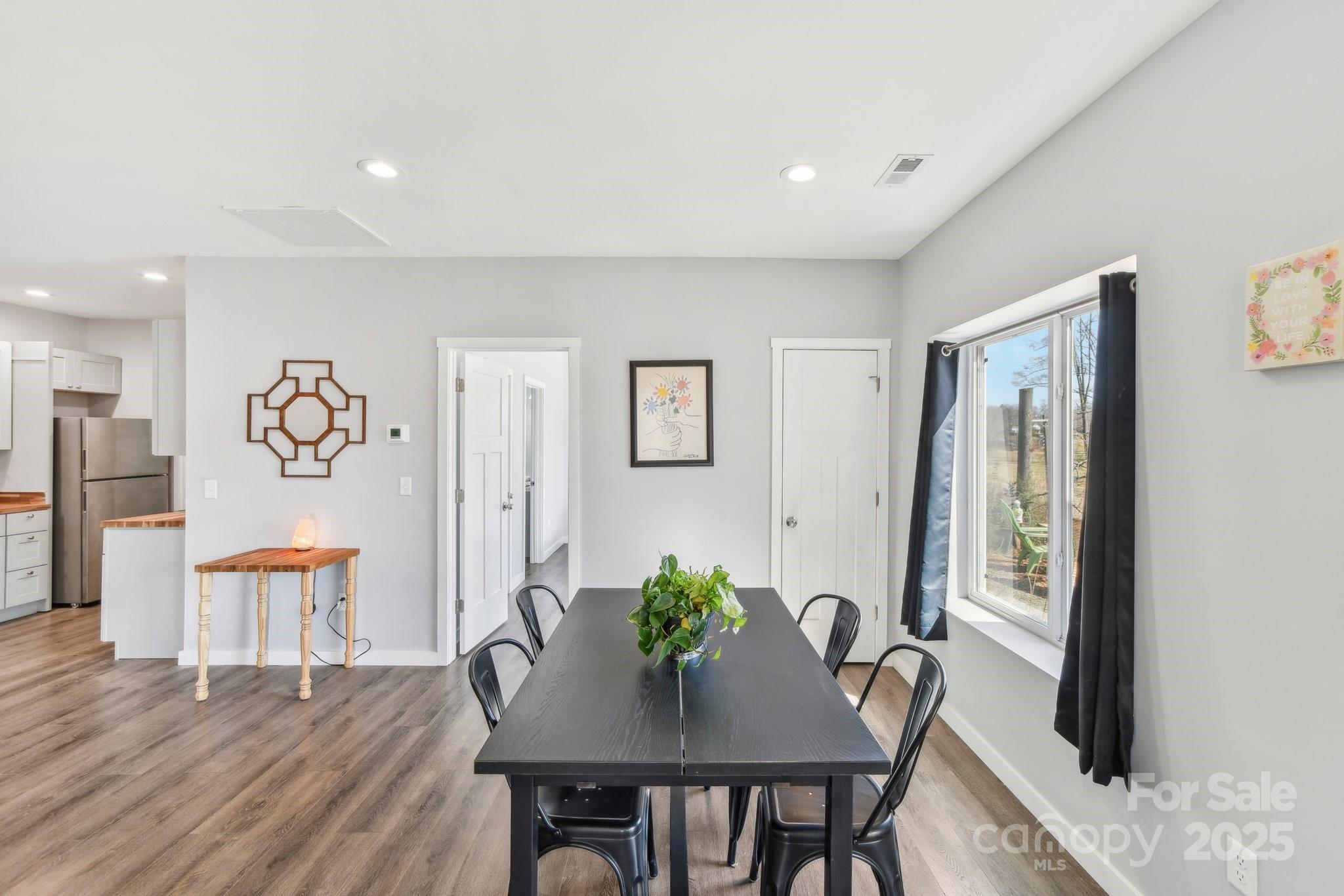 811 Golf Course Road Old Fort, NC 28762 - Photo 7 of 37 a view of a dining room with furniture window and wooden floor