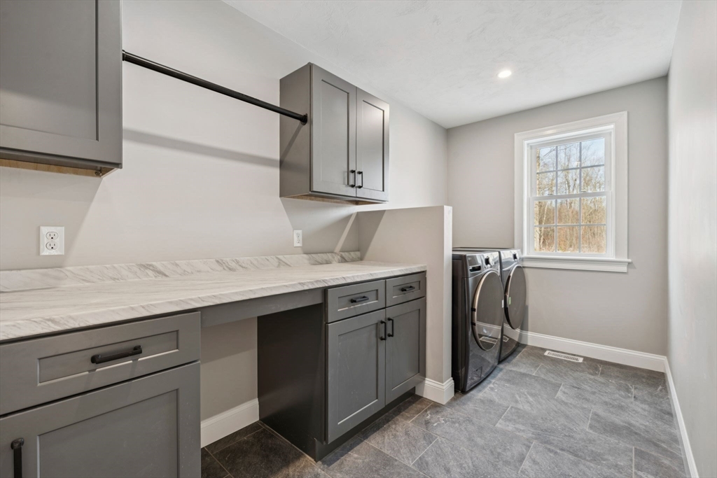 140 Ridge Road Rutland, MA 01543 - Photo 17 of 39 a utility room with granite countertop a sink a washer and dryer