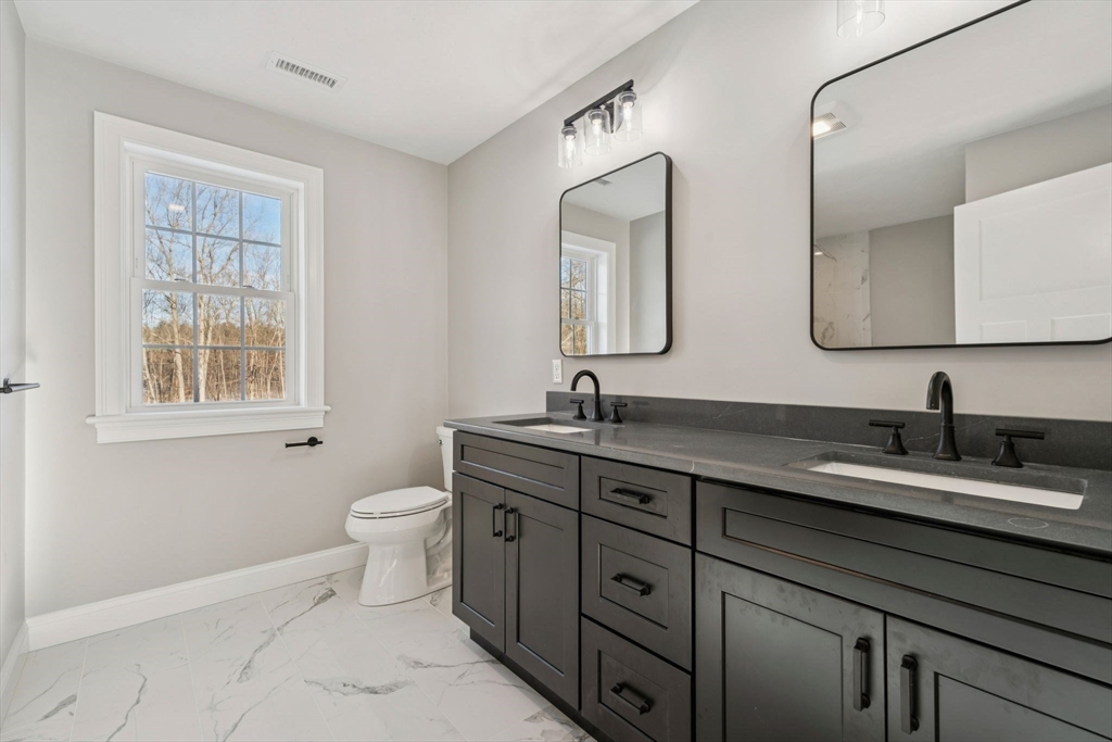 140 Ridge Road Rutland, MA 01543 - Photo 24 of 39 a bathroom with a granite countertop toilet sink and mirror