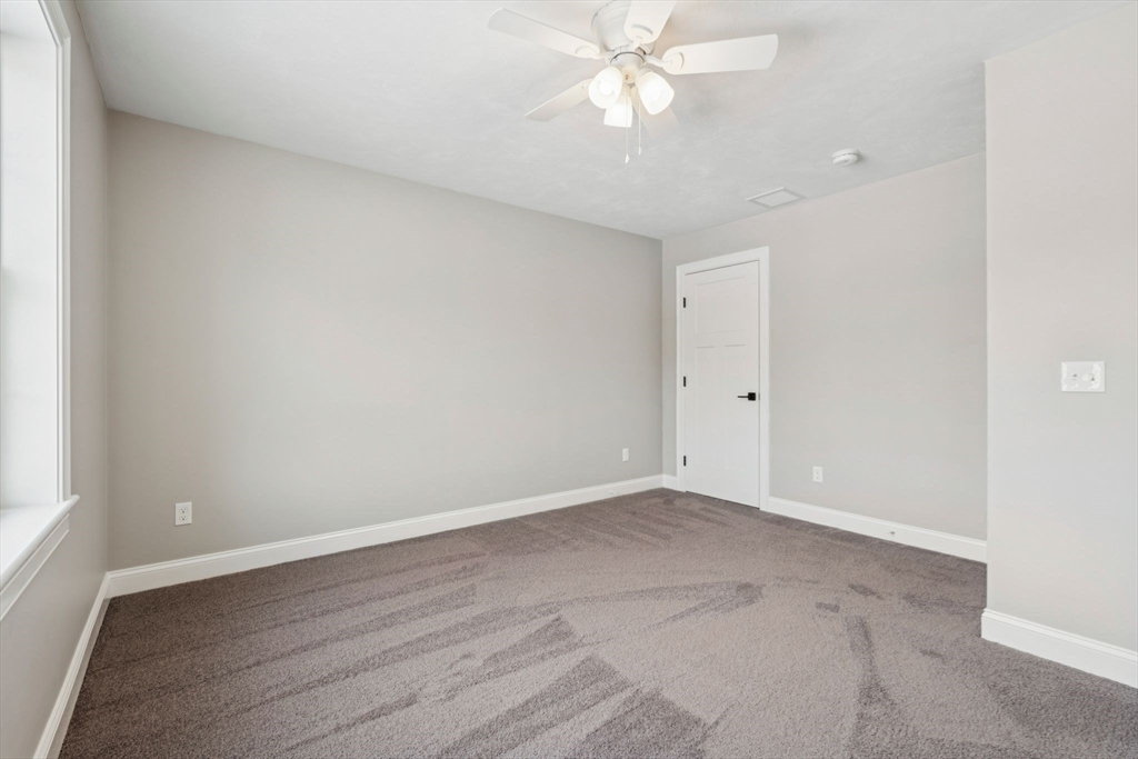 140 Ridge Road Rutland, MA 01543 - Photo 27 of 39 a view of an empty room with wooden floor and a ceiling fan