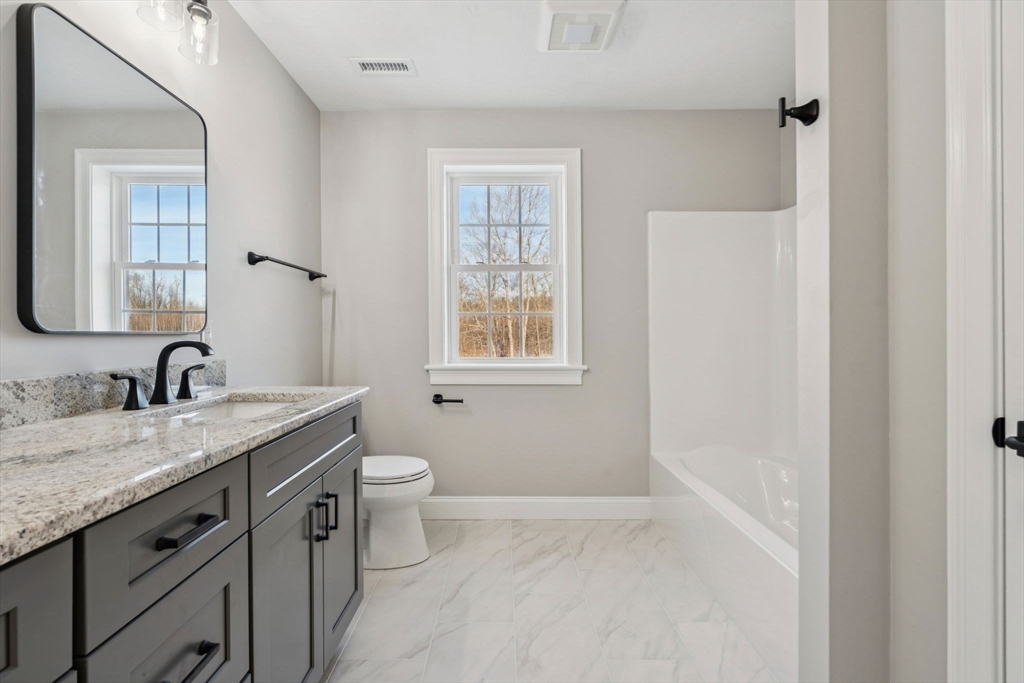 140 Ridge Road Rutland, MA 01543 - Photo 29 of 39 a bathroom with a granite countertop sink toilet and mirror