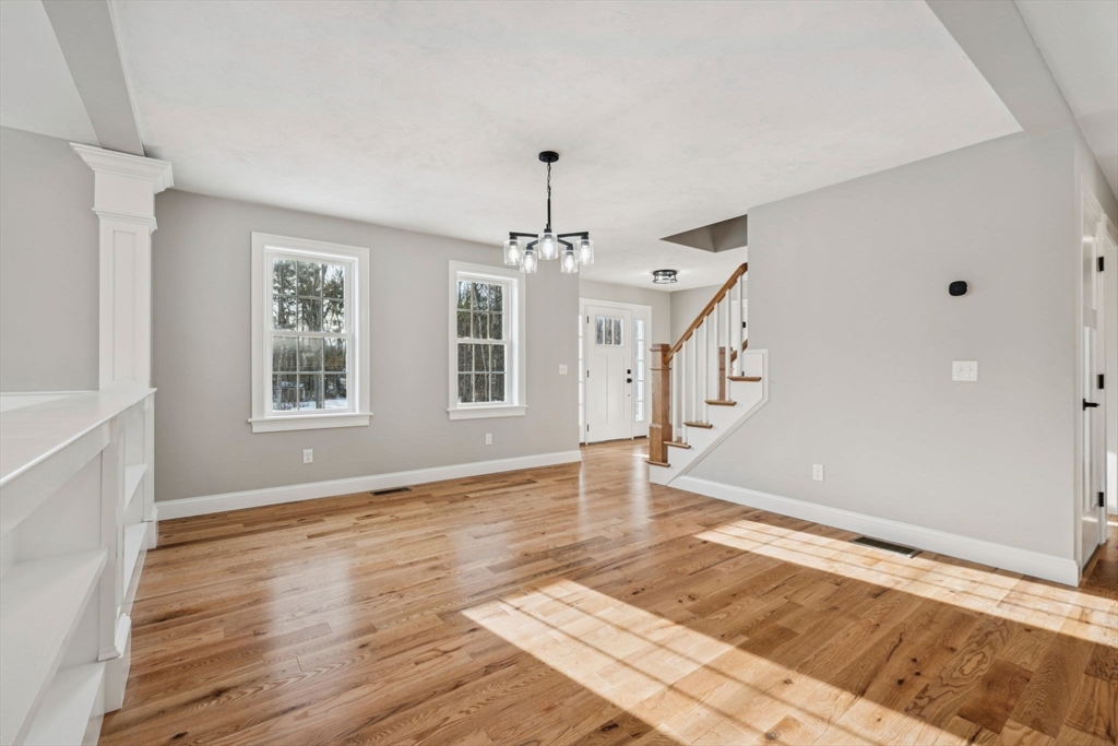 140 Ridge Road Rutland, MA 01543 - Photo 3 of 39 a view of an empty room with wooden floor and a window