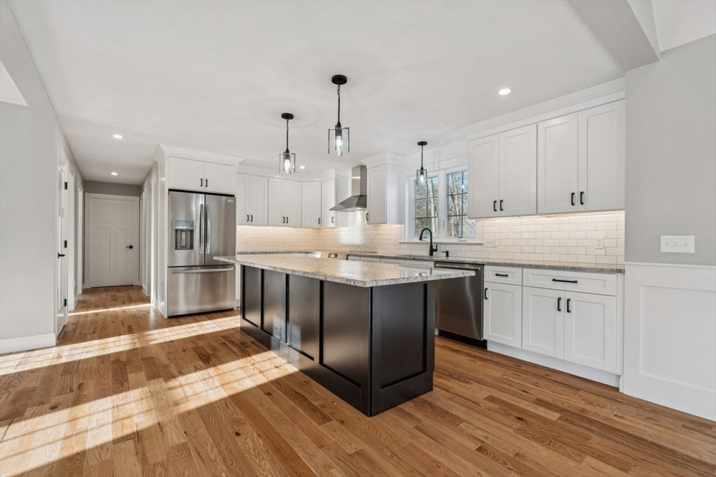 140 Ridge Road Rutland, MA 01543 - Photo 6 of 39 a kitchen with kitchen island granite countertop a sink cabinets and wooden floor