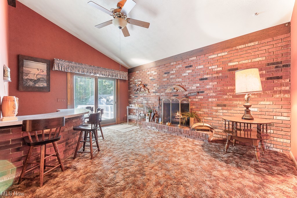 19235 West Middletown Road Beloit, OH 44609 - Photo 16 of 35 Carpeted living room with brick wall and lofted ceiling