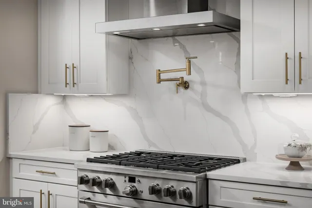 a white stove top oven sitting inside of a kitchen