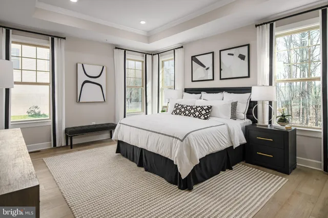 a spacious bedroom with a bed and a window