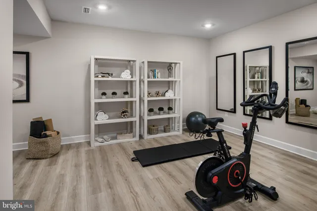 a bedroom with furniture and a wooden floor