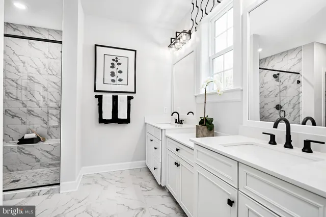 a bathroom with a double vanity sink mirror and shower