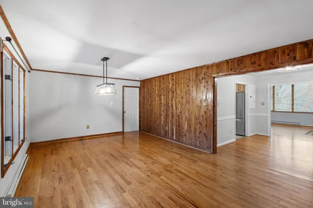 a view of an empty room with wooden floor