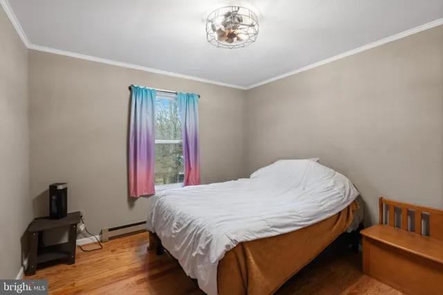 a bed sitting in a bedroom next to a window