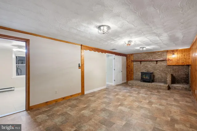 en view interior of a house with stairs and a fireplace