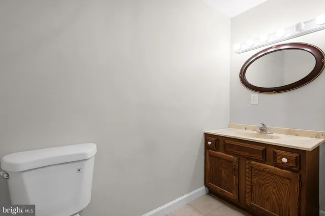 a bathroom with a toilet a sink and a mirror