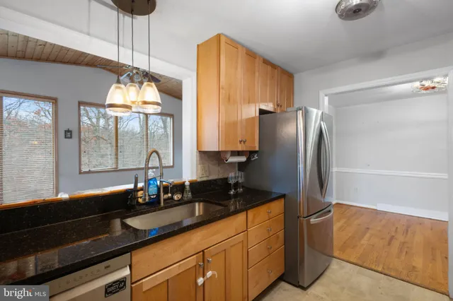 a kitchen with stainless steel appliances granite countertop a refrigerator and a sink