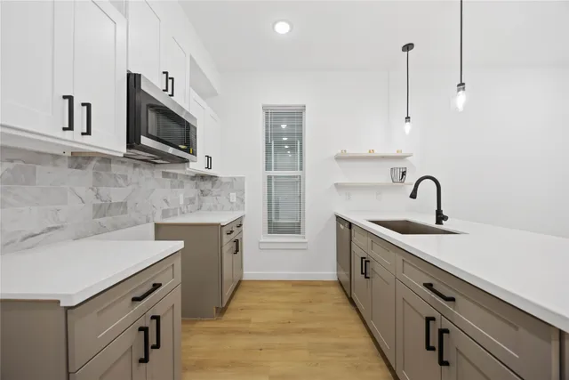 a kitchen with stainless steel appliances granite countertop a sink and a stove top oven