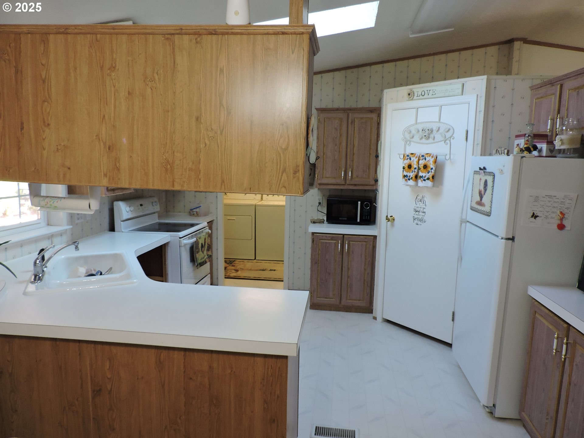 4403 Wagon Wheel Circle Forest Grove, OR 97116 - Photo 4 of 15 a kitchen with stainless steel appliances a refrigerator and a sink