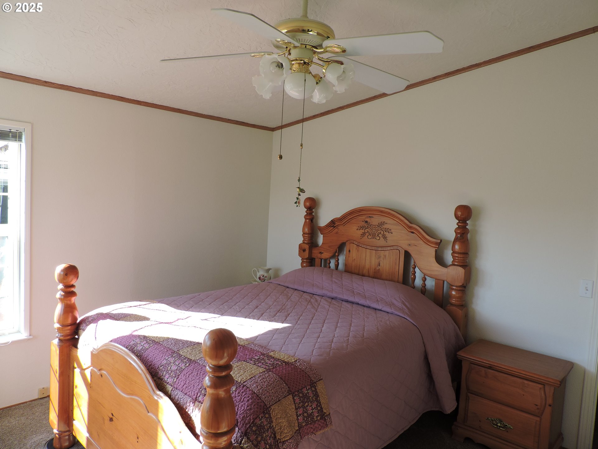 4403 Wagon Wheel Circle Forest Grove, OR 97116 - Photo 8 of 15 a bedroom with a bed and a chandelier