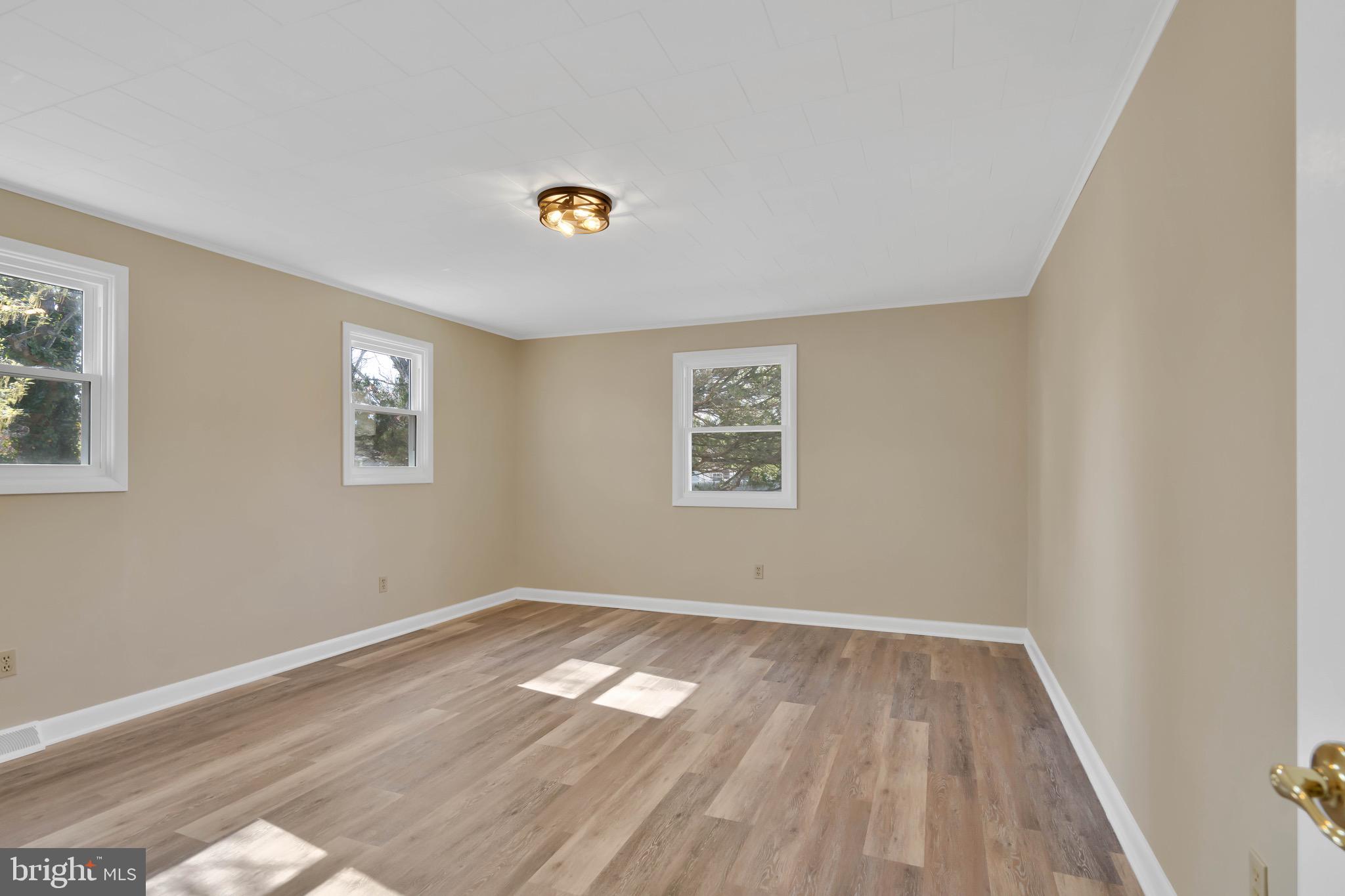 332 Maple Street Millville, NJ 08332 - Photo 11 of 24 wooden floor in an empty room with a window