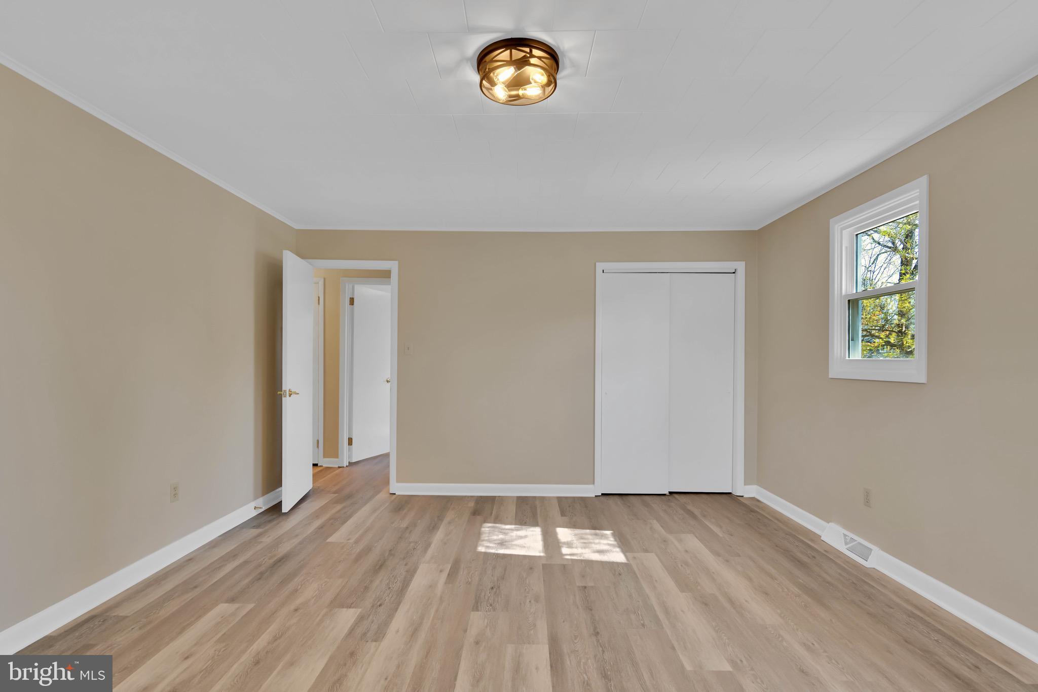 332 Maple Street Millville, NJ 08332 - Photo 12 of 24 an empty room with a window and wooden floor