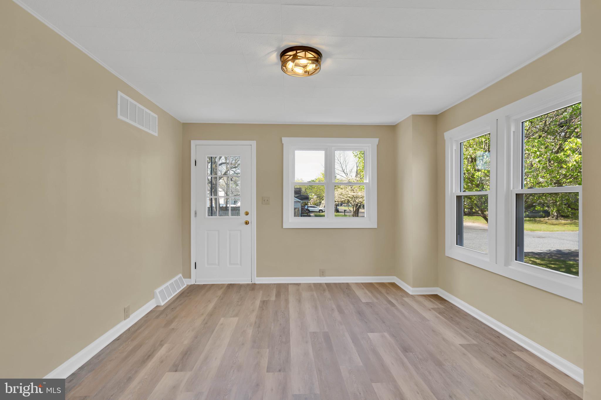 332 Maple Street Millville, NJ 08332 - Photo 14 of 24 an empty room with a window and wooden floor
