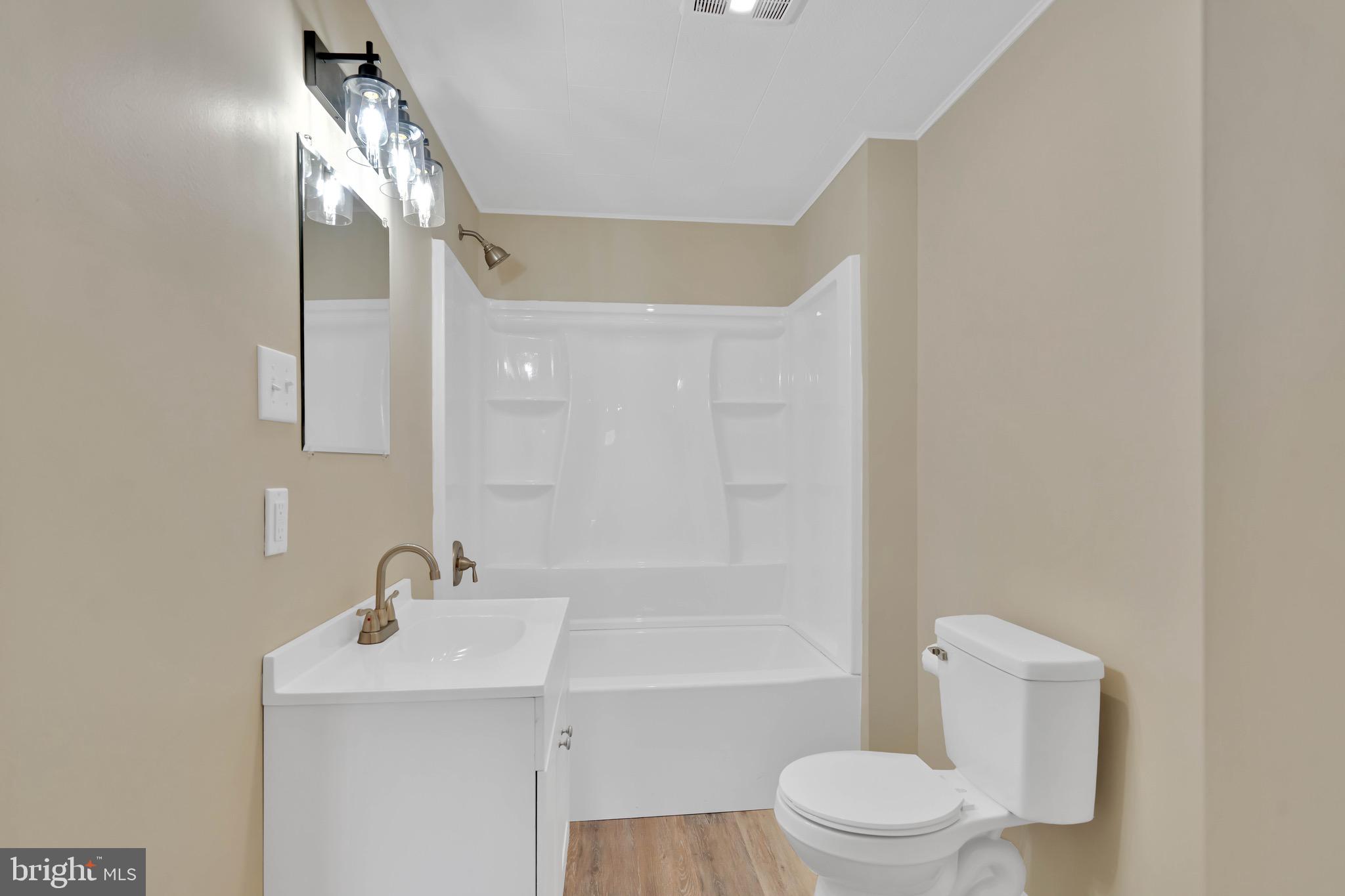 332 Maple Street Millville, NJ 08332 - Photo 8 of 24 a bathroom with a sink a toilet and shower