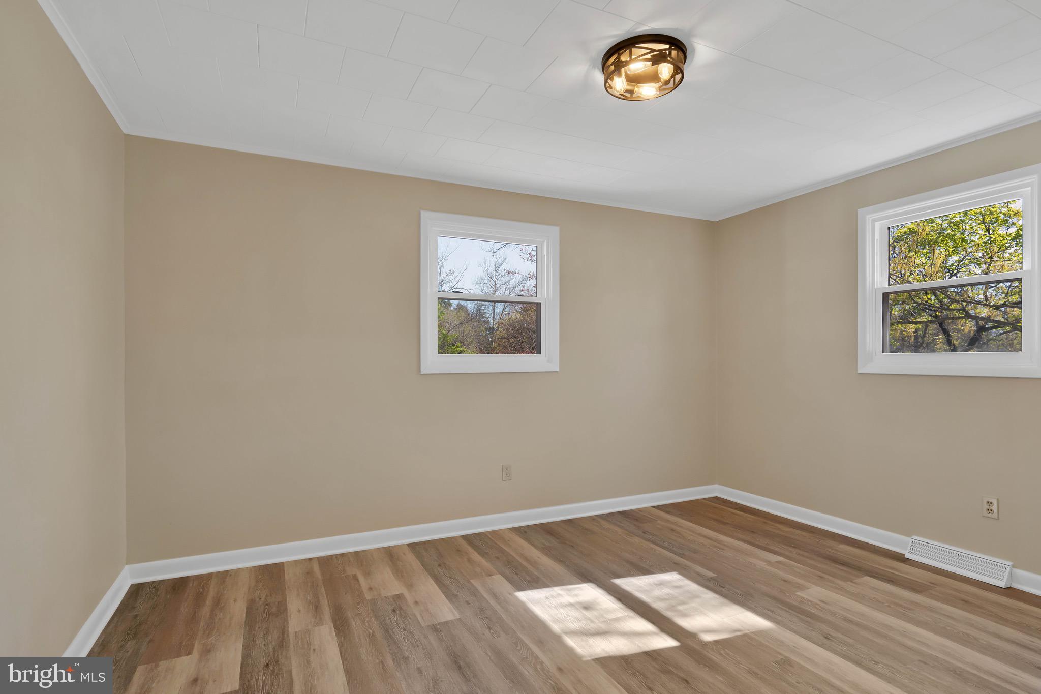 332 Maple Street Millville, NJ 08332 - Photo 9 of 24 a view of an empty room with a window and wooden floor