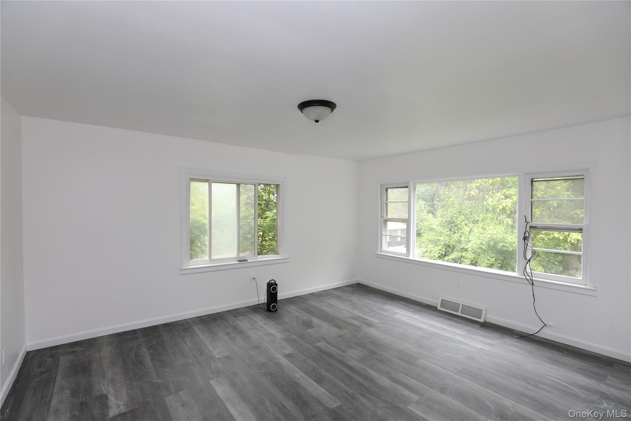 17 Rear Chapel Street Ellenville, NY 12428 - Photo 11 of 24 a view of an empty room with wooden floor and a window