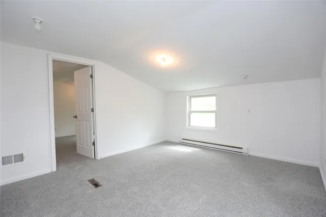 an empty room with a empty space and windows