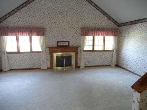 5N585 Dunham Trails Road Wayne, IL 60184 - Photo 4 of 9 an empty room with a fireplace and windows