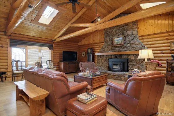 a living room with furniture and a book shelf