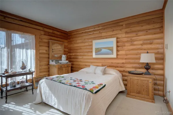 a bedroom with furniture and a chandelier
