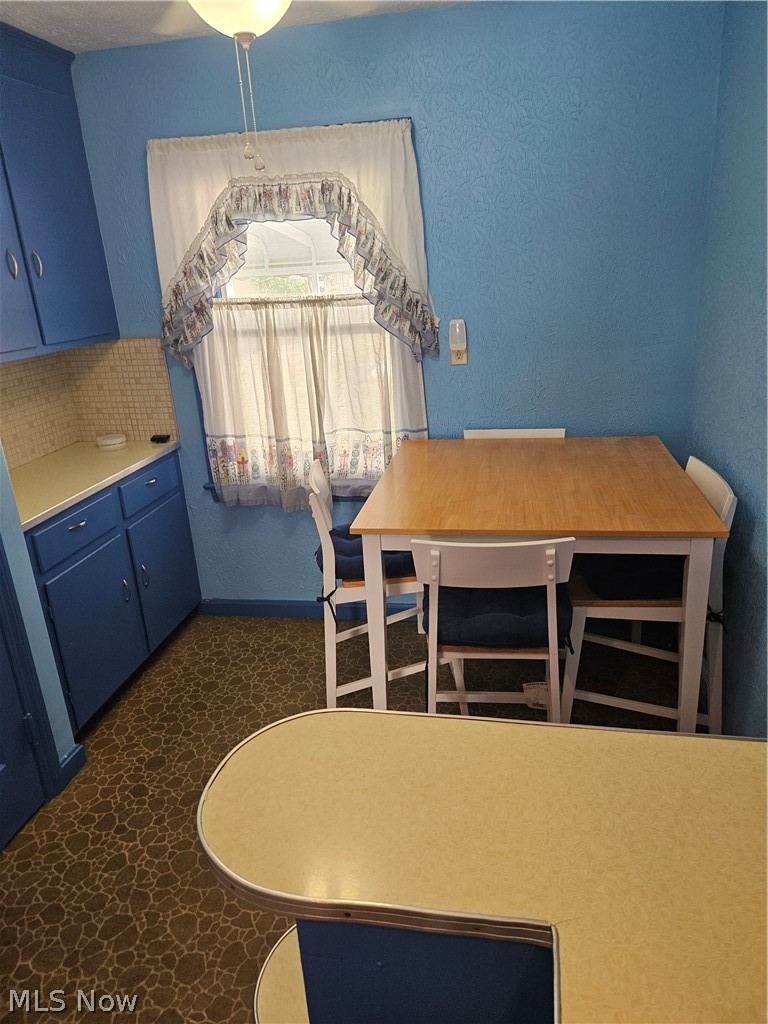 4516 Fulton Road Cleveland, OH 44144 - Photo 10 of 17 Kitchen featuring blue cabinets and tasteful backsplash