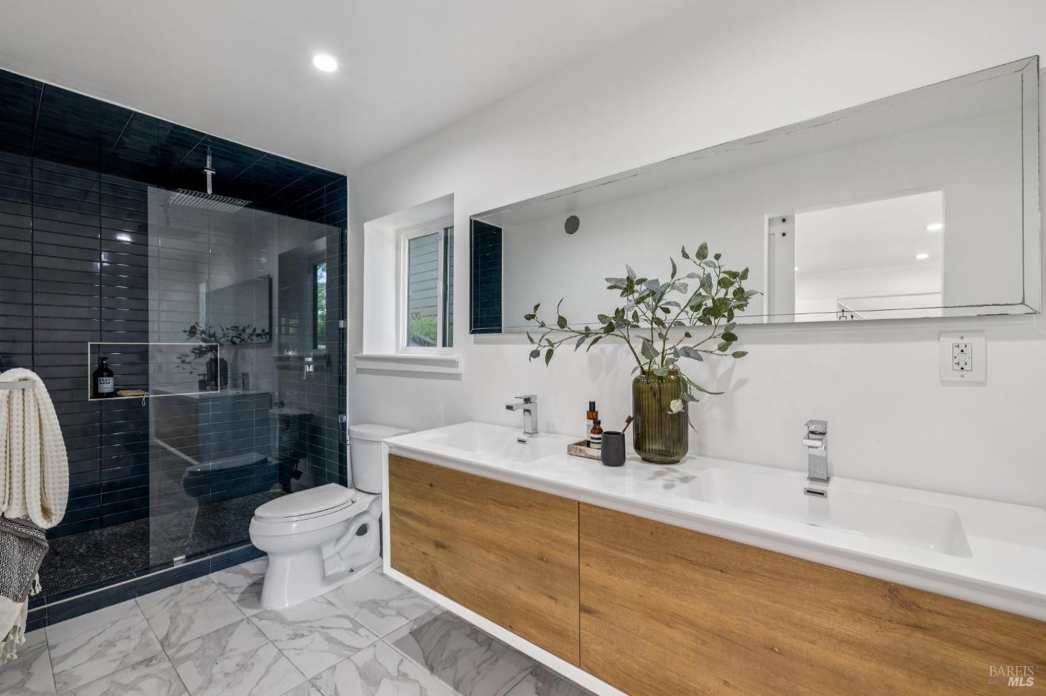 227 Coleman Drive San Rafael, CA 94901 - Photo 6 of 36 a bathroom with a double vanity sink toilet and a mirror