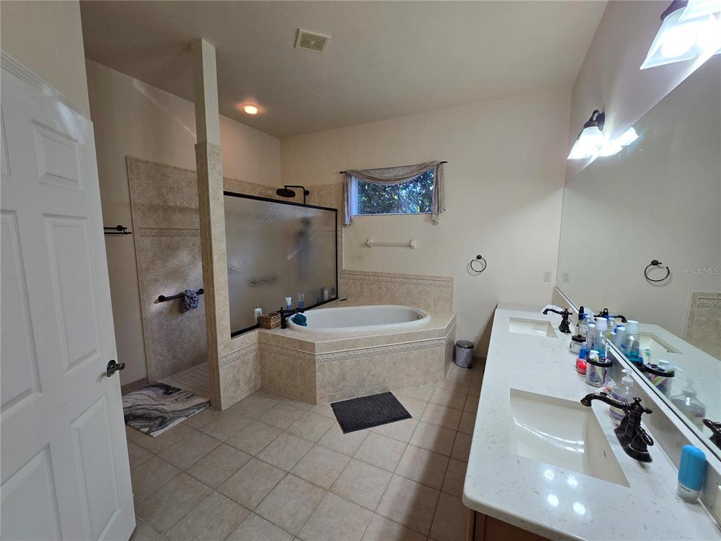 8613 Southwest 76th Place Gainesville, FL 32608 - Photo 15 of 30 a bathroom with a sink toilet and shower