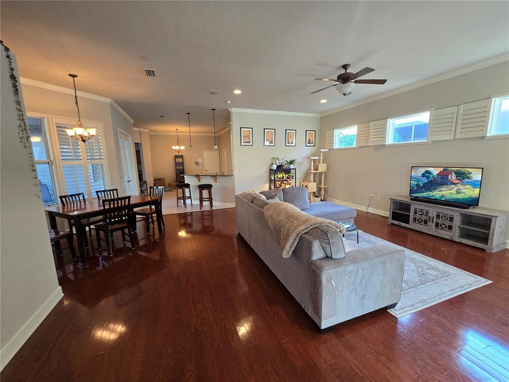 8613 Southwest 76th Place Gainesville, FL 32608 - Photo 5 of 30 a living room with furniture and a wooden floor