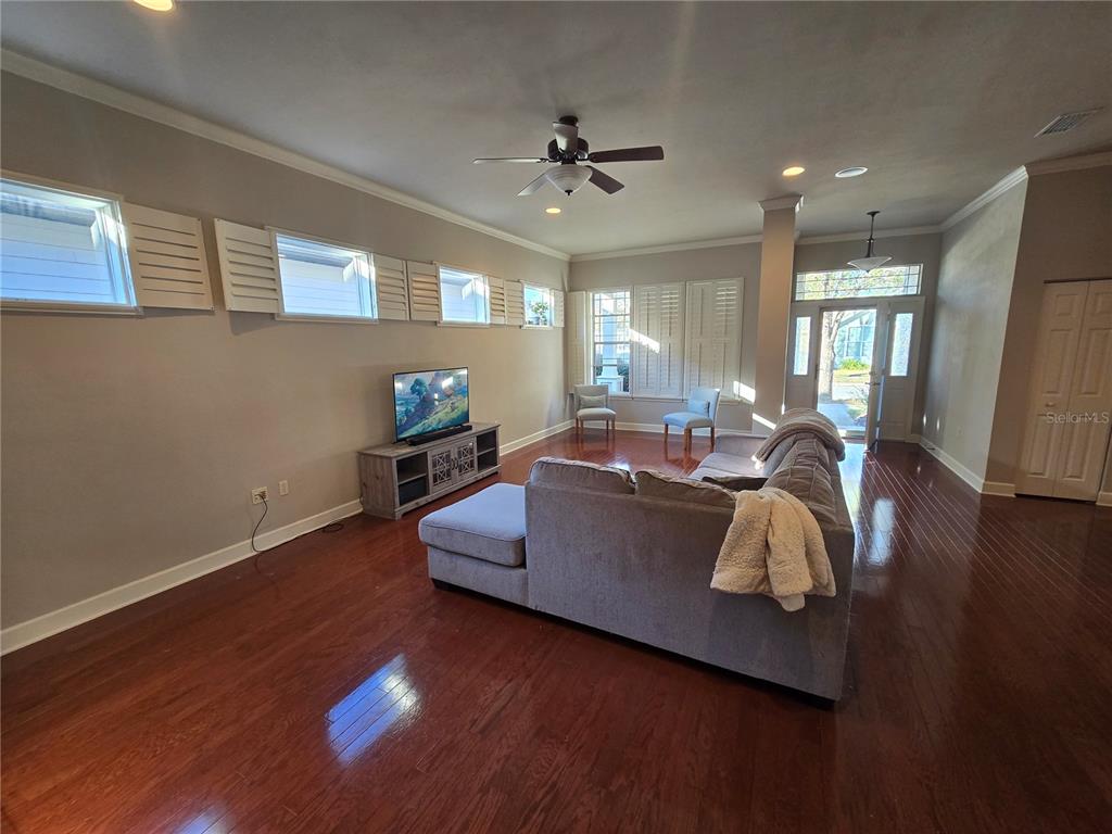 8613 Southwest 76th Place Gainesville, FL 32608 - Photo 7 of 30 a living room with furniture and a wooden floor