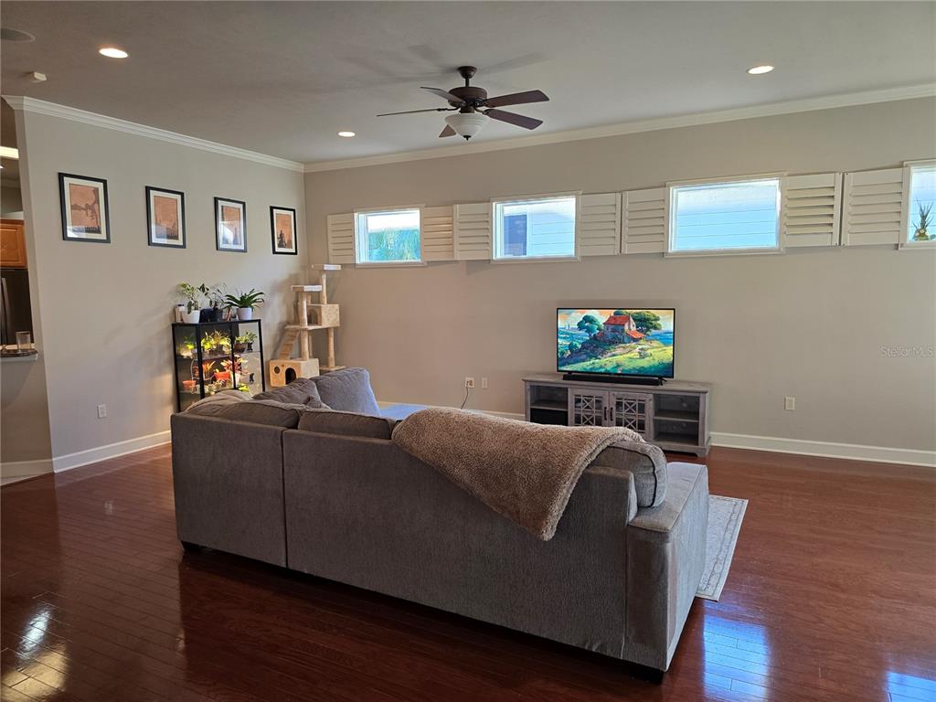 8613 Southwest 76th Place Gainesville, FL 32608 - Photo 9 of 30 a living room with furniture and a wooden floor