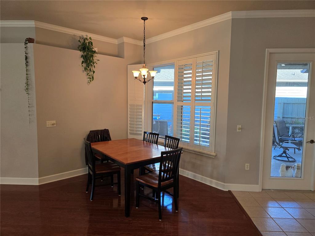 8613 Southwest 76th Place Gainesville, FL 32608 - Photo 10 of 30 a view of a dining room with furniture window and wooden floor