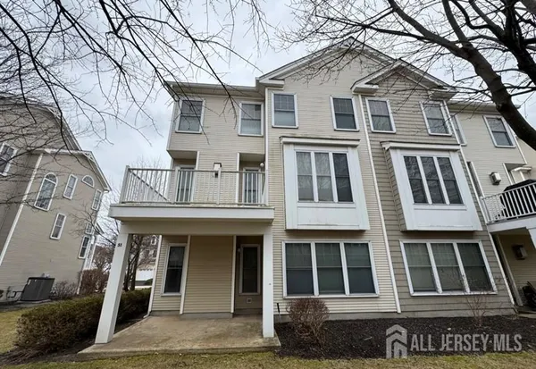 a front view of a house with a tree