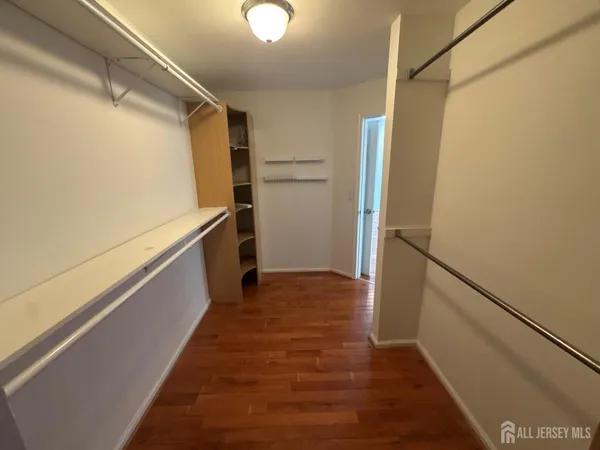 a view of a storage and utility room with refrigerator